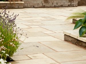 Natural stone paving materials arranged on a surface, highlighting their durability and resistance to cracking.