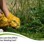Person in yellow gloves pulling weeds in lawn to estimate weeding cost by area.